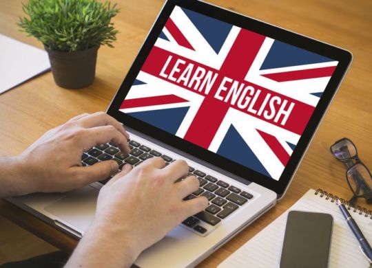learn english concept. Close-up top view of english learning on laptop. all screen graphics are made up.
