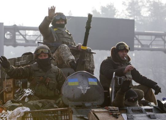 Ukrainian servicemen ride atop an armoured personnel carrier (APC), as they return from the frontline in eastern Ukraine, in Kiev March 11, 2015. One Ukrainian serviceman has been killed and four wounded in fighting in separatist eastern territories in the past 24 hours despite a ceasefire deal, a Ukrainian military spokesman said on Wednesday. REUTERS/Valentyn Ogirenko (UKRAINE - Tags: MILITARY POLITICS CONFLICT)